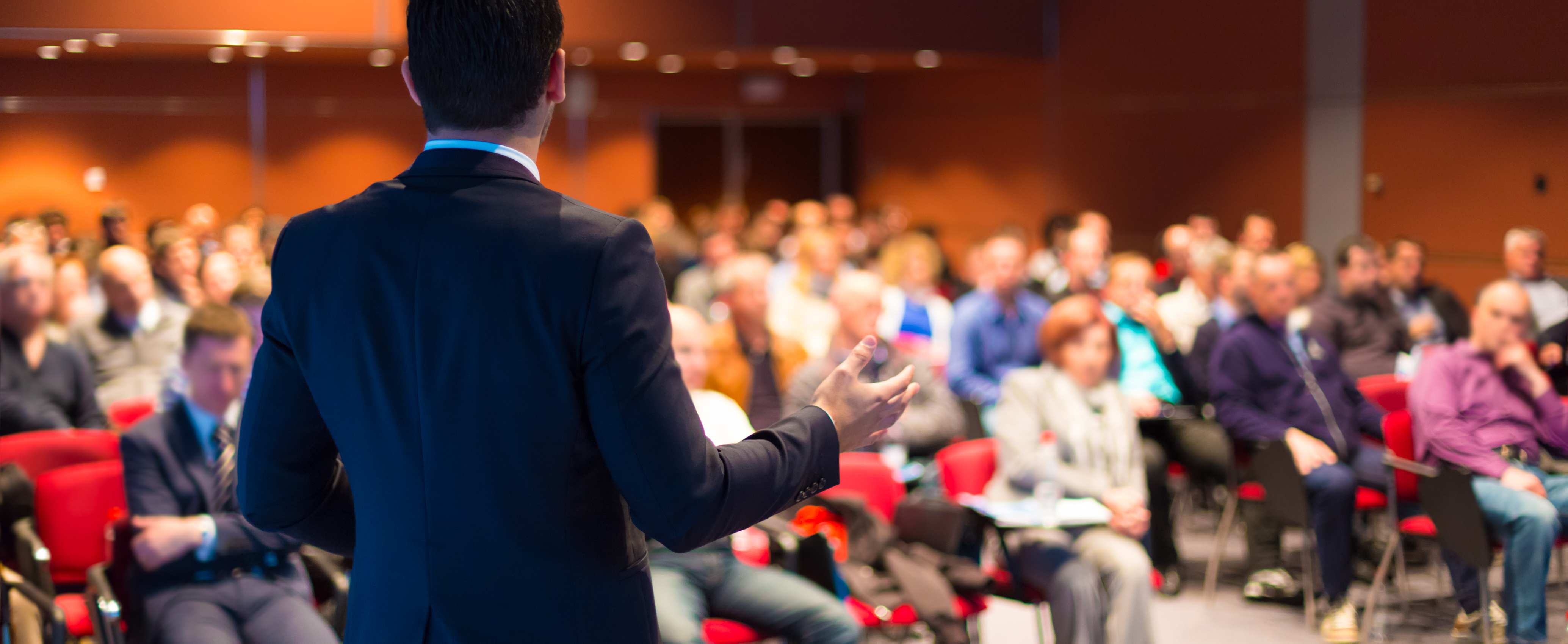 Conference goers hearing speech