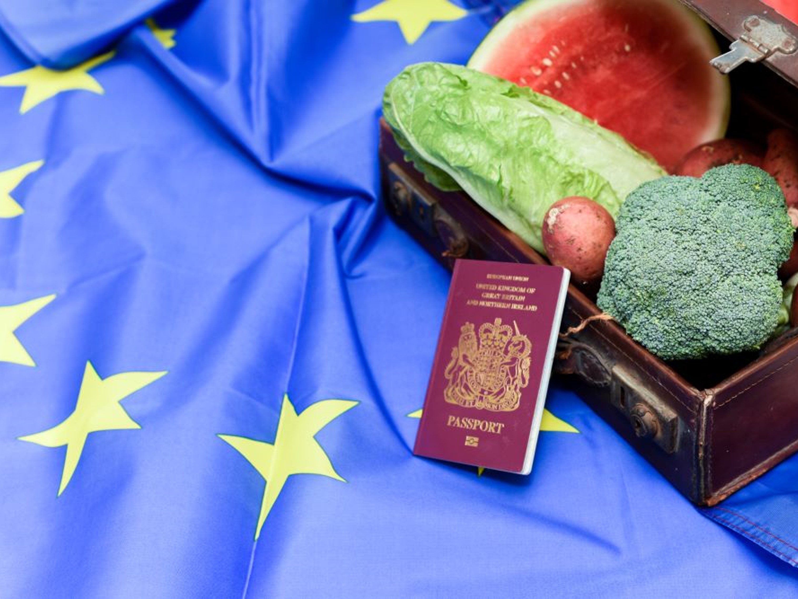 Food laid on a EU flag with a British passport