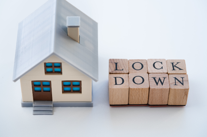 model house with lockdown on wooden blocks