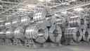 Rolls of aluminium stacked in a factory 