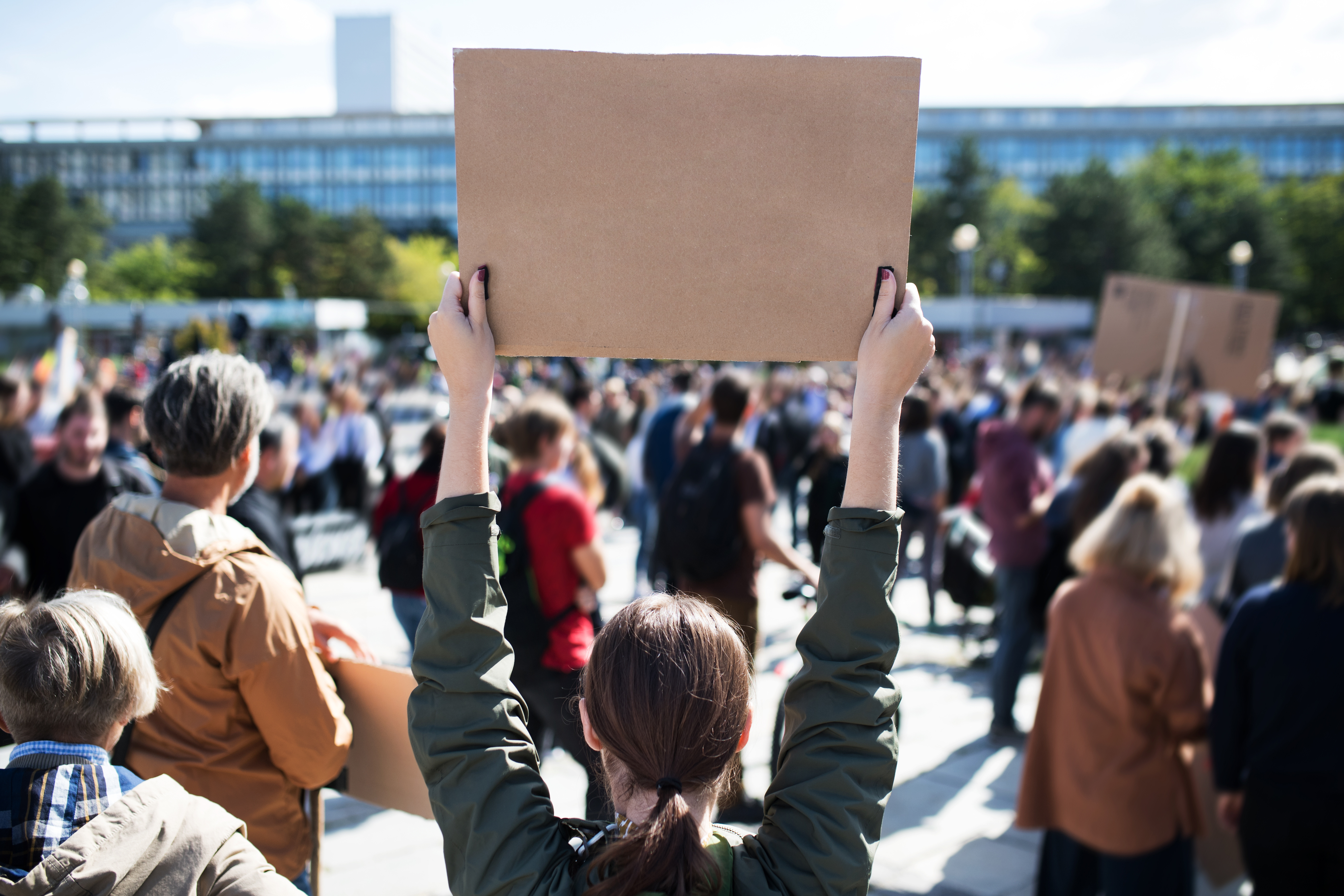 Woman striker at picket line with sign