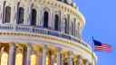 US Congress building dome with US flag flying in foreground