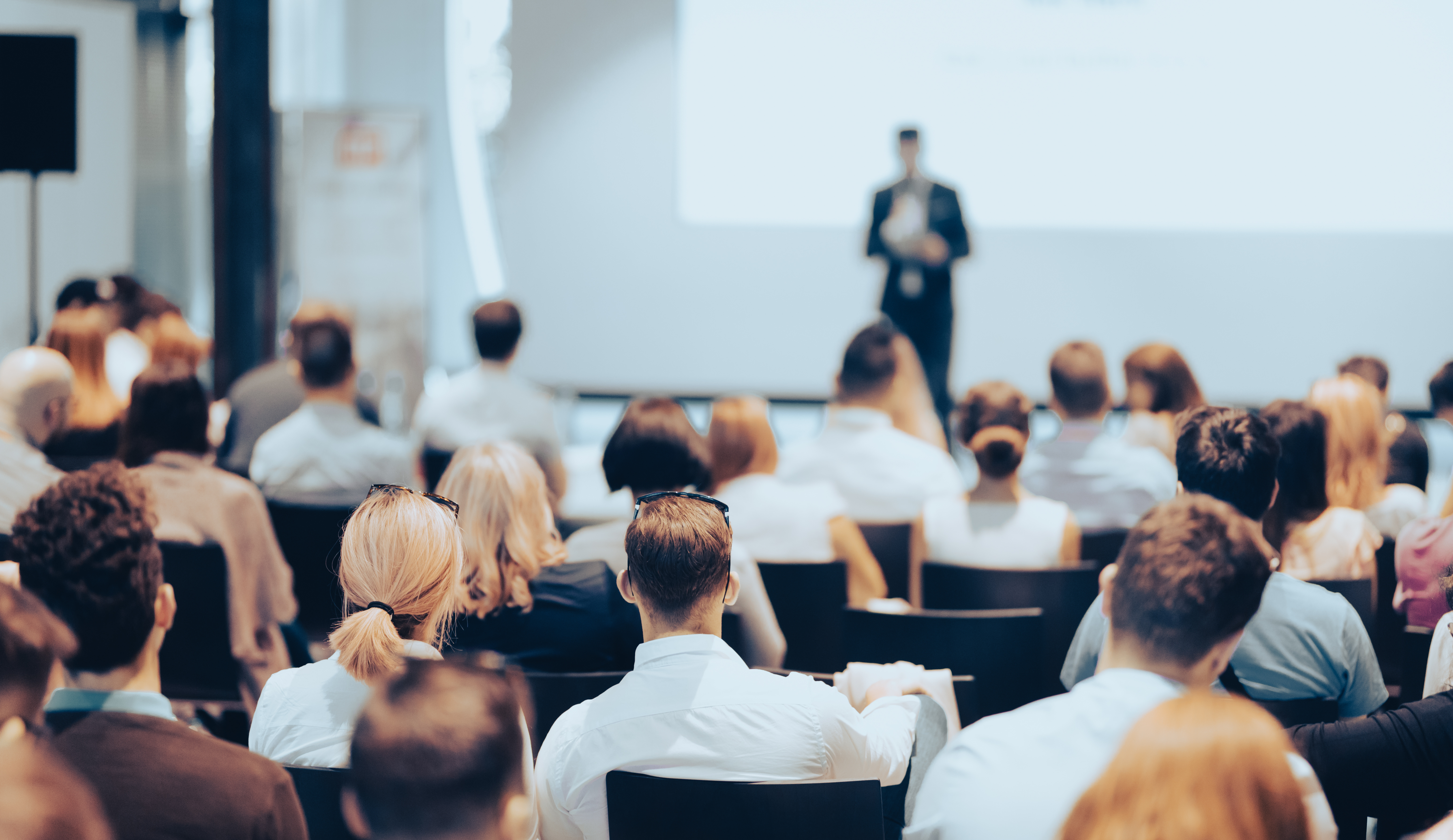 Conference goers hearing speech