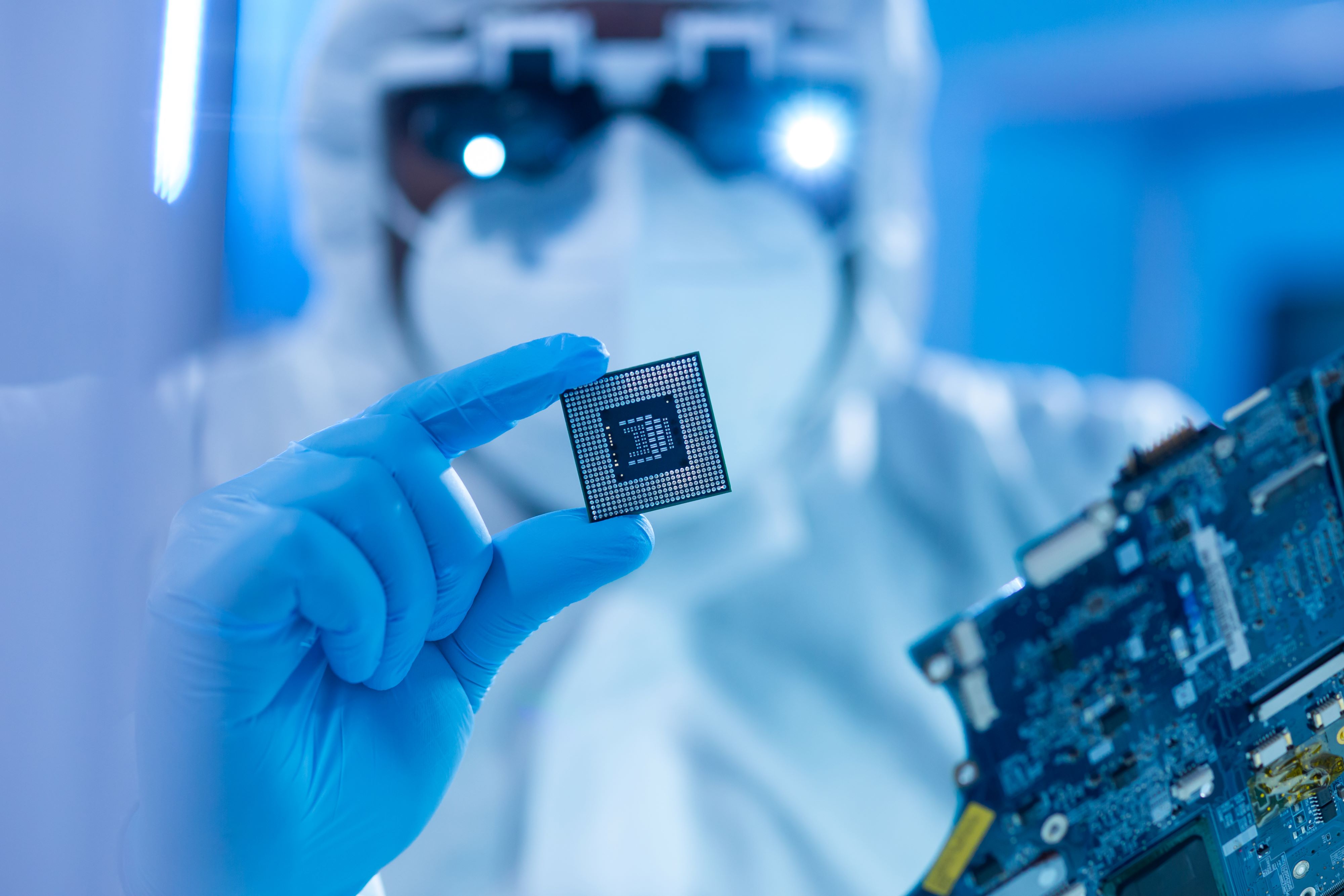 Microchip being inspected by scientist in lab equipment 