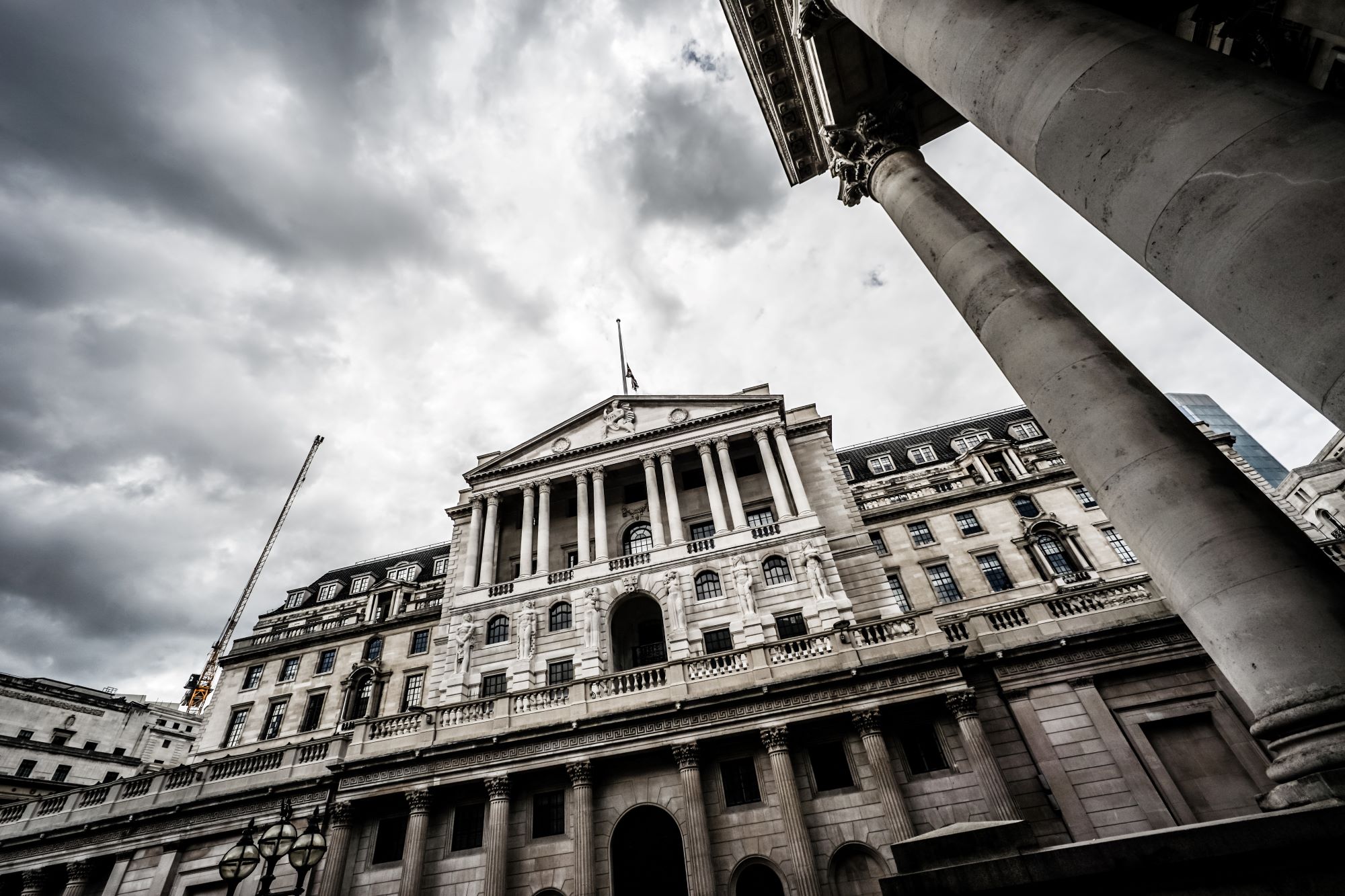 Front of Bank of England with grey clouds swirling behind