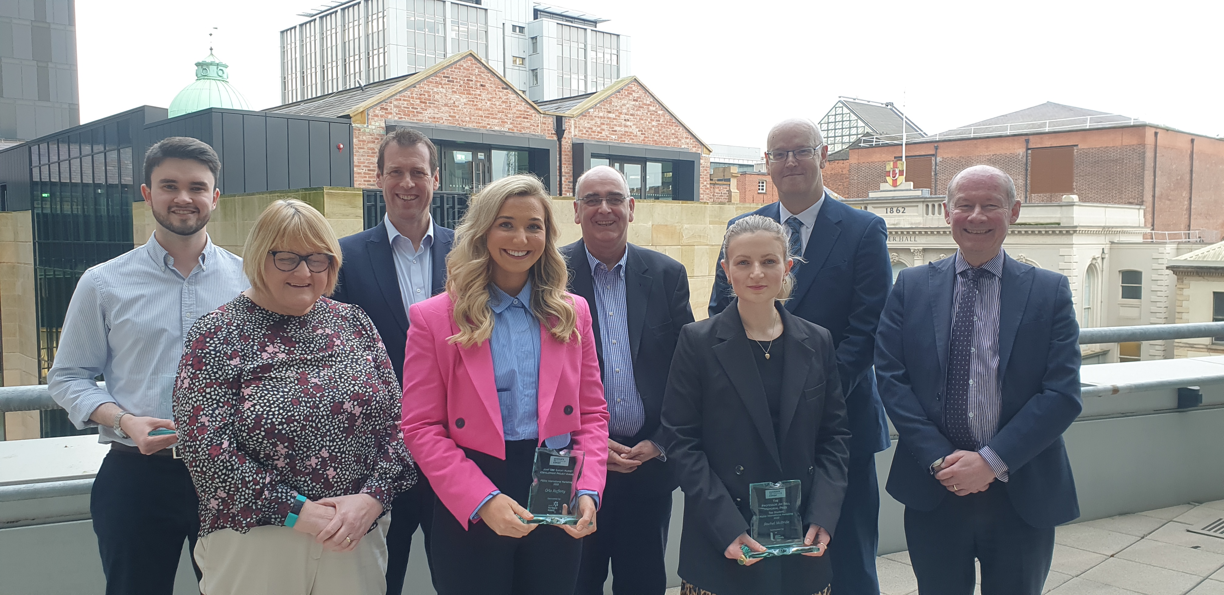 Members of NI graduation class with IOE&IT representatives